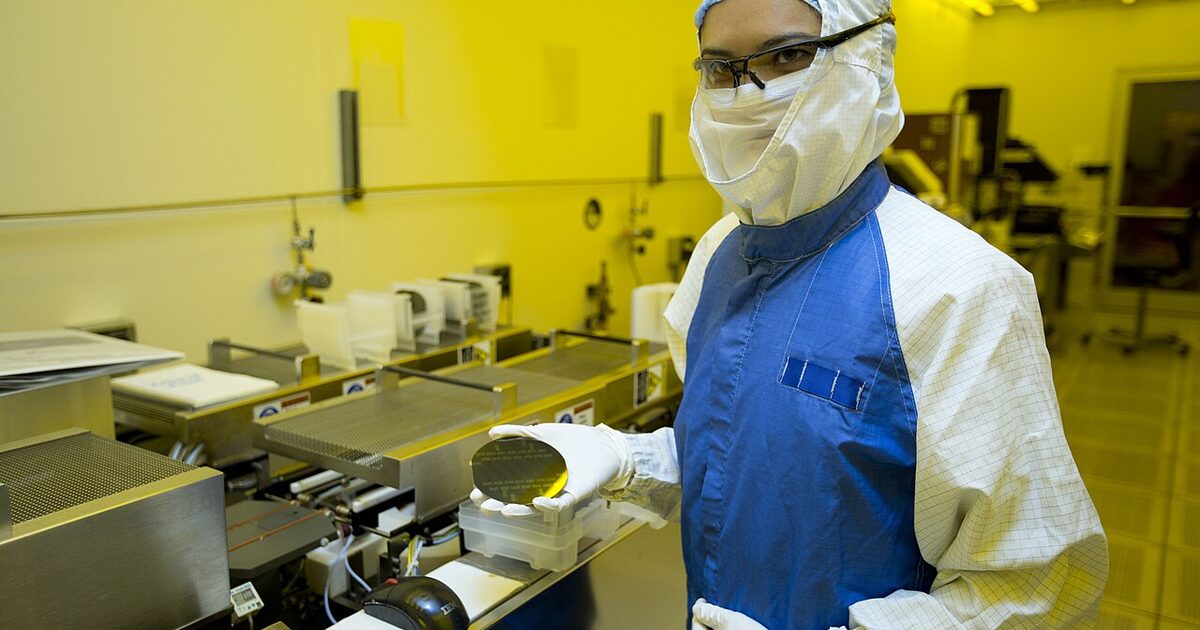A researcher inspecting a silicon wafer