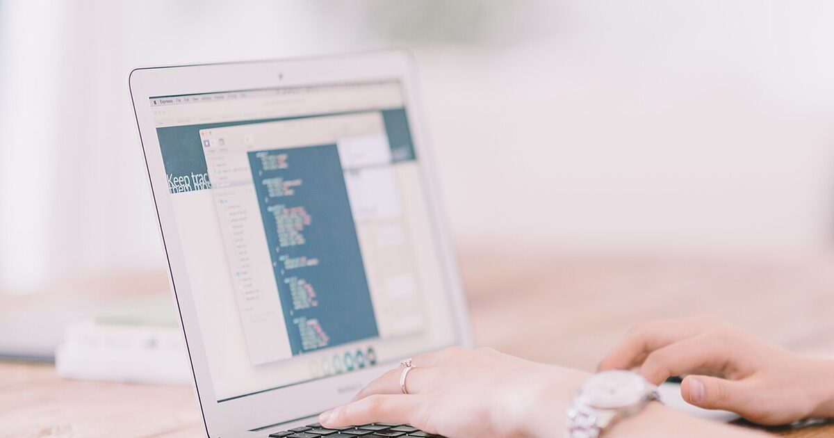 A software developer working at a laptop